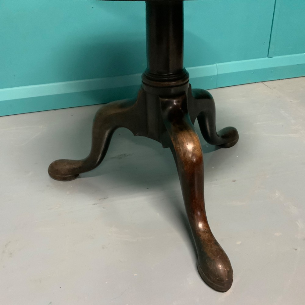 A George II mahogany two-tier dumb waiter with graduated circular surfaces, a turned central column, and a tripod base. View IV