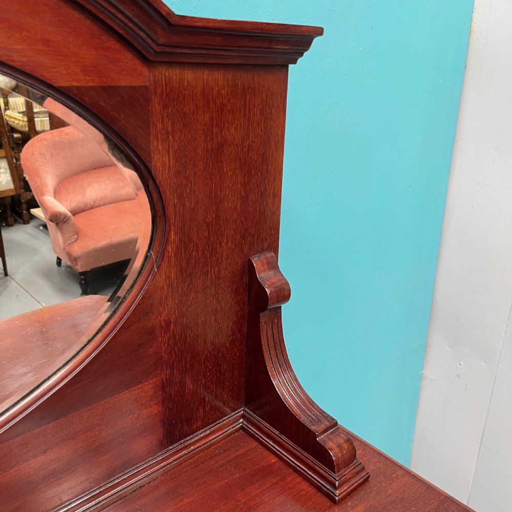An Edwardian mahogany mirror-back sideboard featuring chevron parquetry cupboard doors, two top drawers, brass pulls, and cabriole legs. View VI