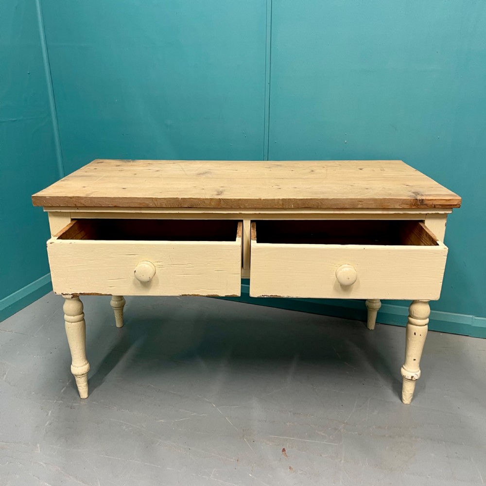 An antique pine server featuring a scrubbed rectangular wooden top, a cream-painted base, two drawers with round wooden knobs, and four turned legs. View II