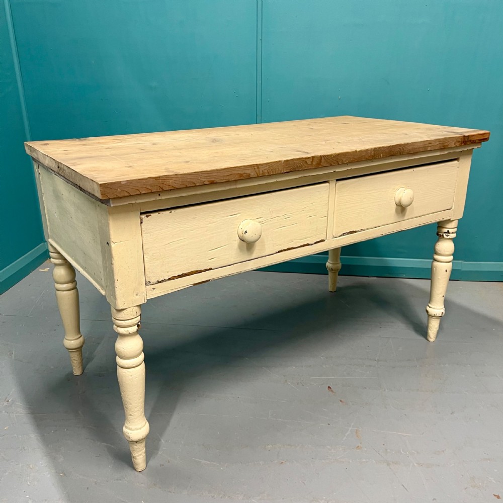 An antique pine server featuring a scrubbed rectangular wooden top, a cream-painted base, two drawers with round wooden knobs, and four turned legs. View III