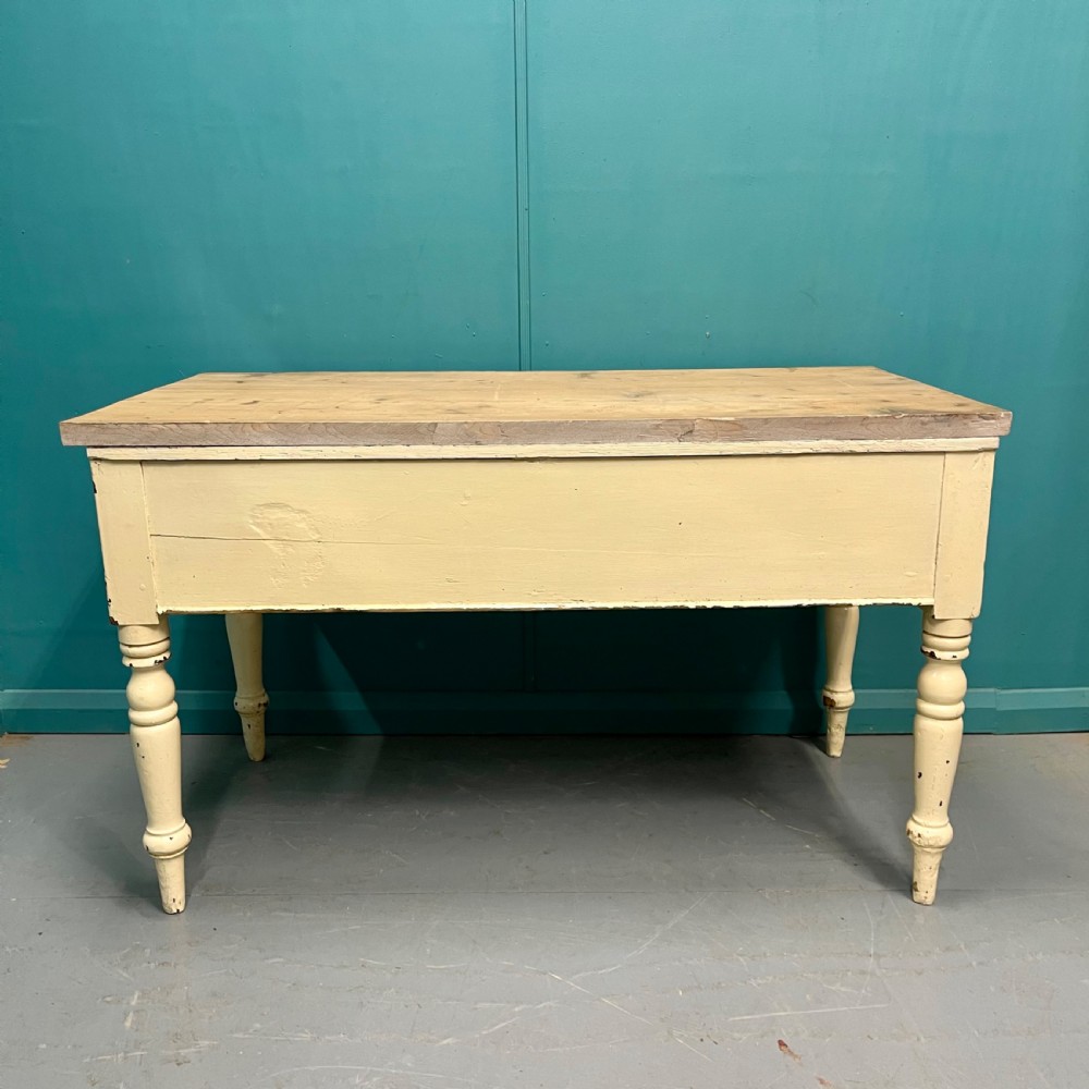 An antique pine server featuring a scrubbed rectangular wooden top, a cream-painted base, two drawers with round wooden knobs, and four turned legs. View VIII