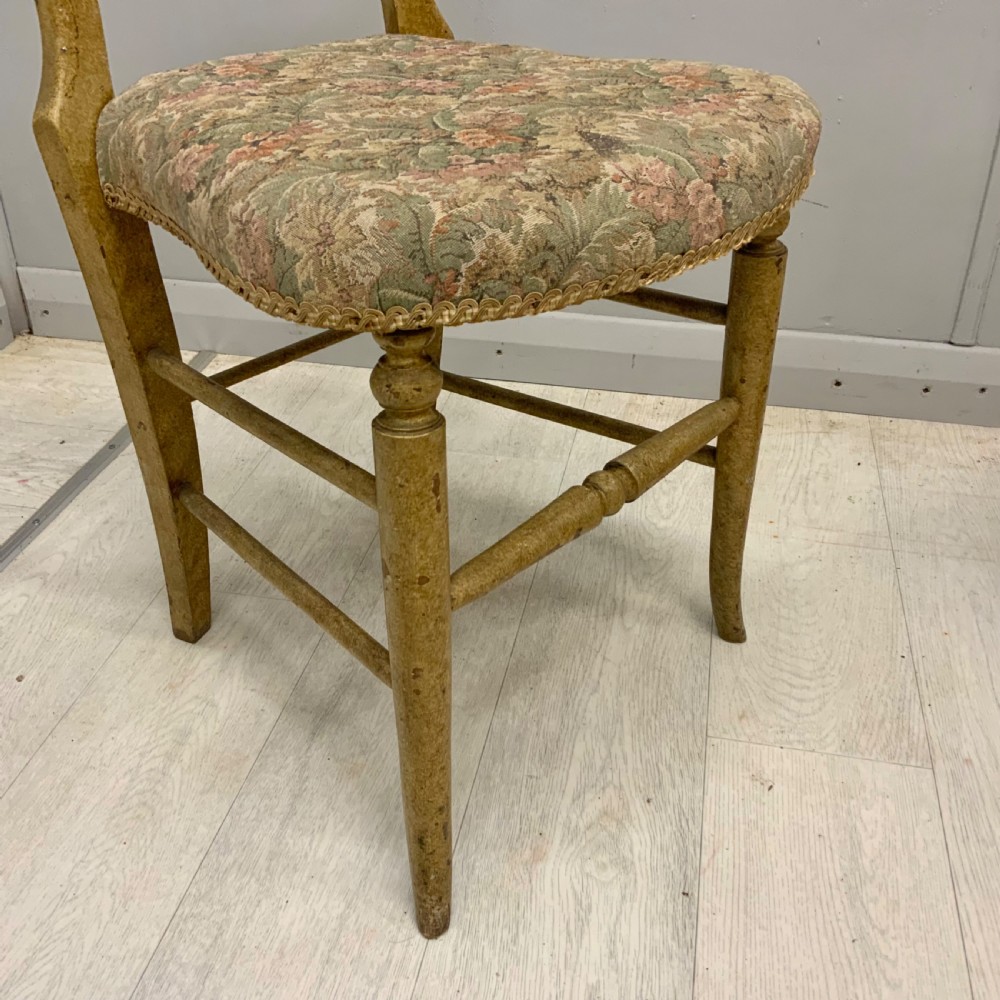 A pair of antique Victorian balloon back side chairs featuring ochre scumble glazed wood frames, turned legs, and floral tapestry upholstered seats. View III