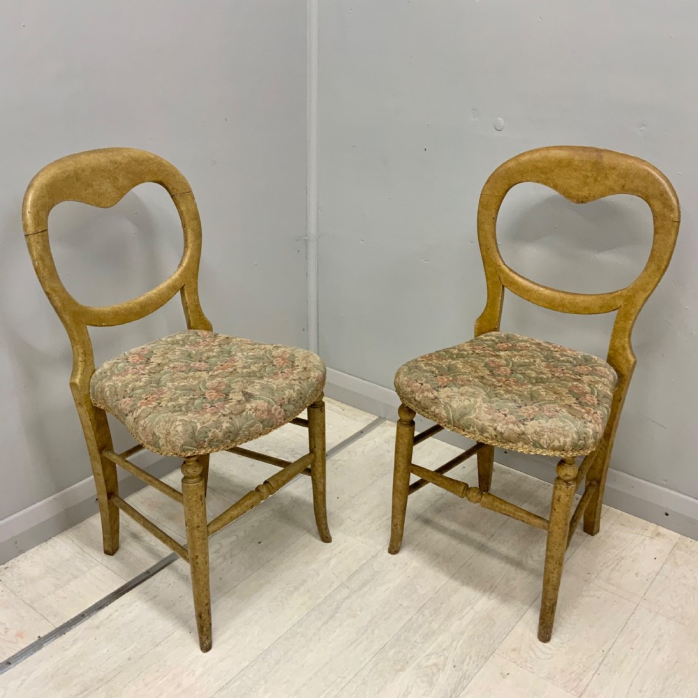 A pair of antique Victorian balloon back side chairs featuring ochre scumble glazed wood frames, turned legs, and floral tapestry upholstered seats. View IV