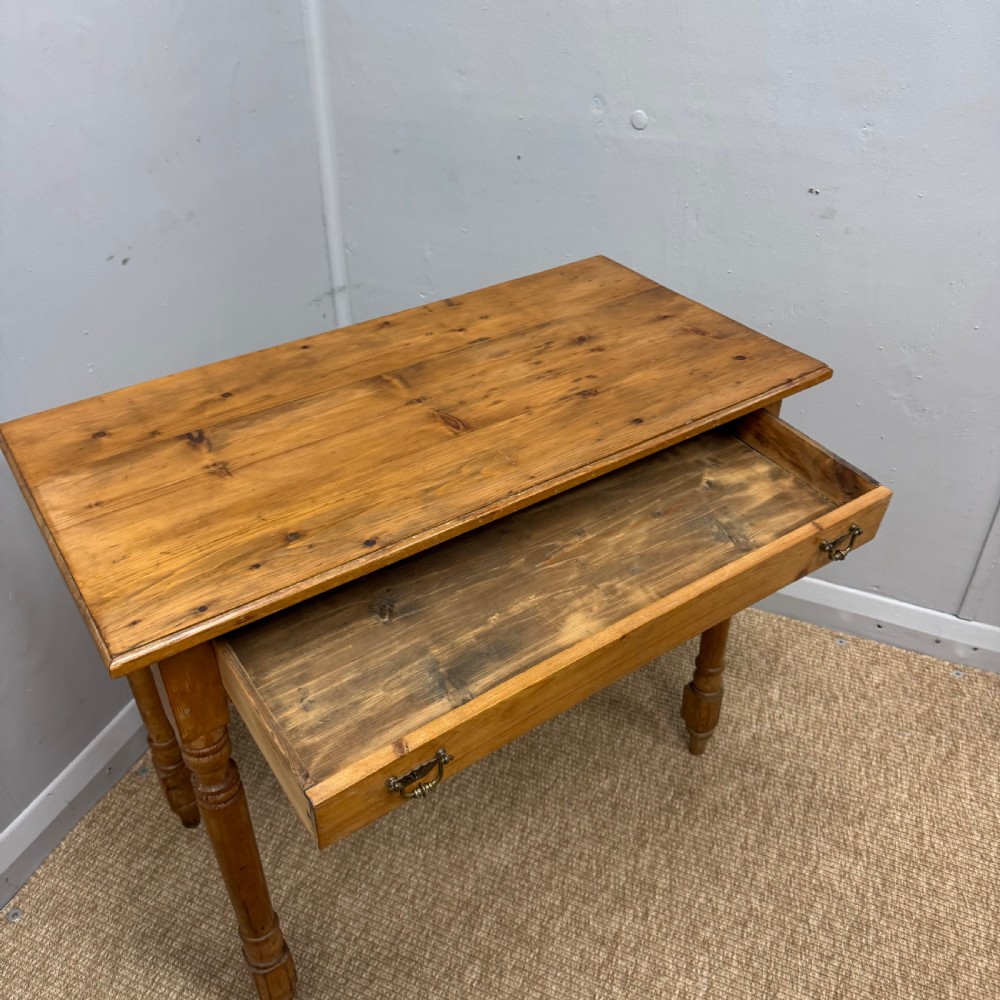 A 19th-century Victorian pine side table with turned legs and a single frieze drawer fitted with brass handles. View II