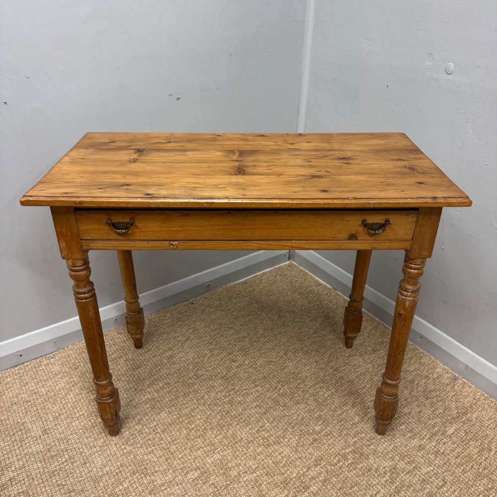 A 19th-century Victorian pine side table with turned legs and a single frieze drawer fitted with brass handles. View IV
