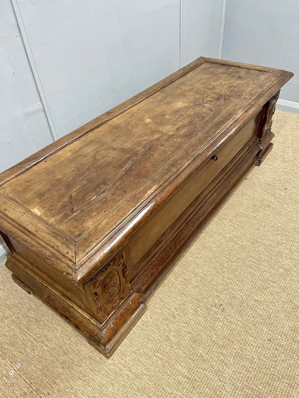 A large 17th-century Italian walnut marriage chest featuring carved corner pilasters, recessed front panels, and a plinth base. View II