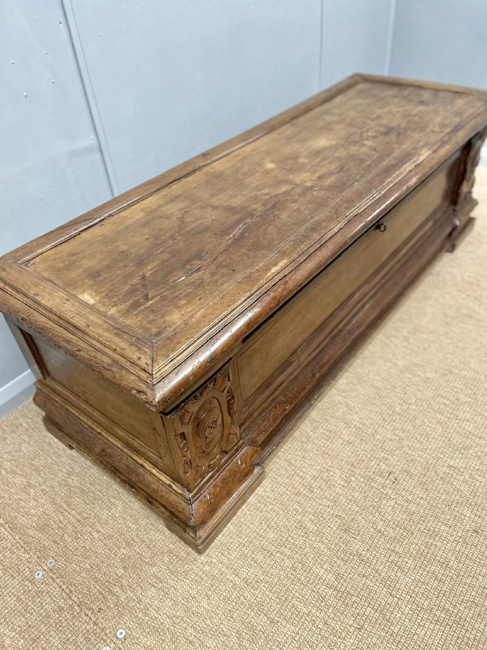 A large 17th-century Italian walnut marriage chest featuring carved corner pilasters, recessed front panels, and a plinth base. View III