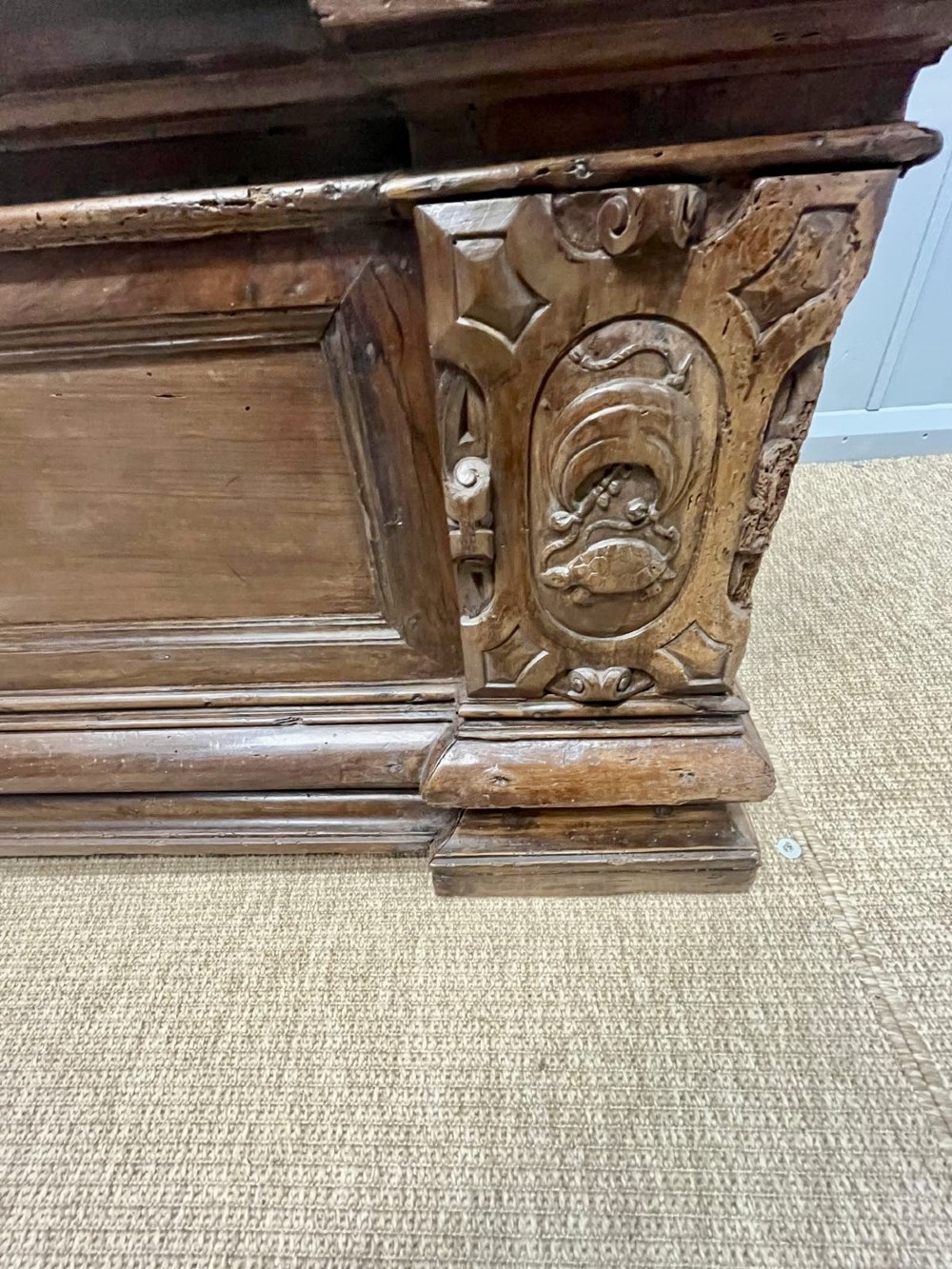 A large 17th-century Italian walnut marriage chest featuring carved corner pilasters, recessed front panels, and a plinth base. View VII