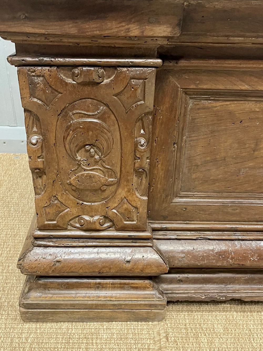 A large 17th-century Italian walnut marriage chest featuring carved corner pilasters, recessed front panels, and a plinth base. View VIII