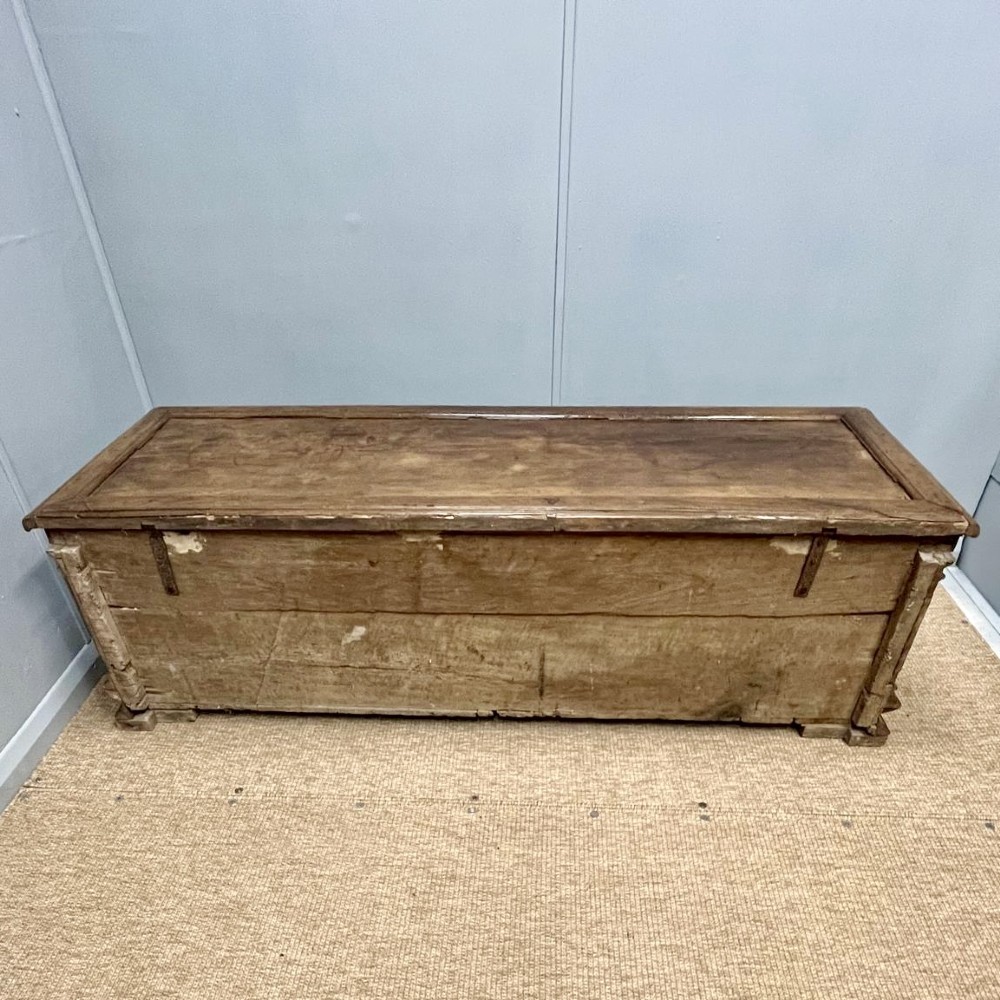 A large 17th-century Italian walnut marriage chest featuring carved corner pilasters, recessed front panels, and a plinth base. View IX