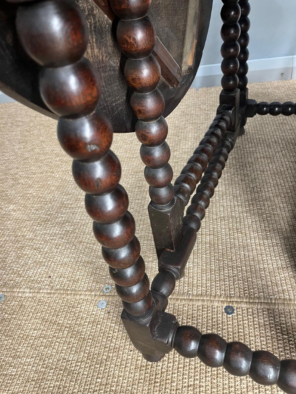 A dark oak gateleg table featuring an oval drop-leaf top, bobbin-turned legs, and matching turned stretchers. View VI