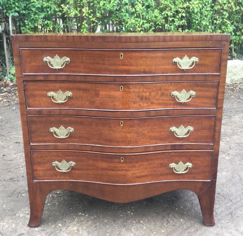 SERPENTINE MAHOGANY CHEST OF DRAWERS