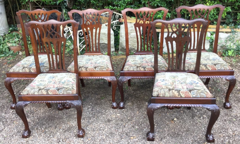 A set of six mahogany Chippendale style dining chairs featuring carved pierced splats and patterned tapestry seats. View II