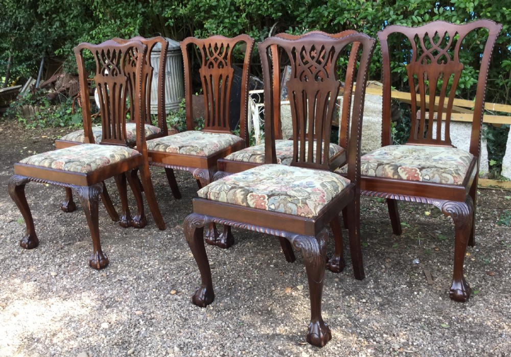 A set of six mahogany Chippendale style dining chairs featuring carved pierced splats and patterned tapestry seats. View III