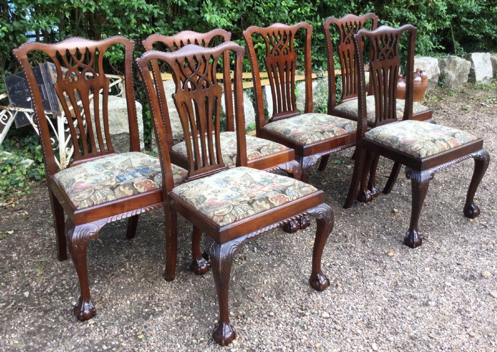 A set of six mahogany Chippendale style dining chairs featuring carved pierced splats and patterned tapestry seats. View IV