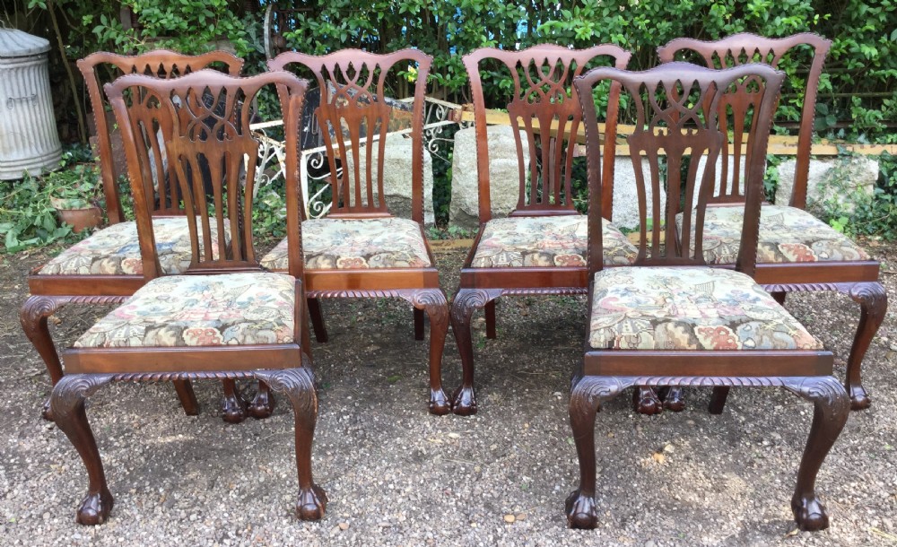 A set of six mahogany Chippendale style dining chairs featuring carved pierced splats and patterned tapestry seats. View V