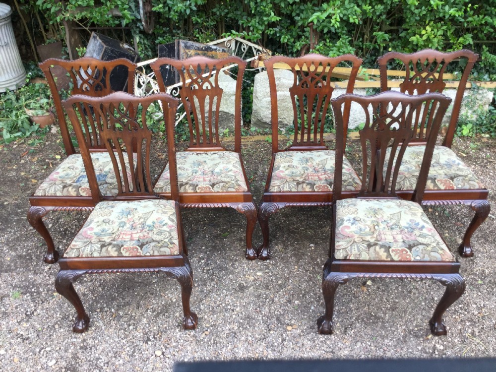 A set of six mahogany Chippendale style dining chairs featuring carved pierced splats and patterned tapestry seats. View VI
