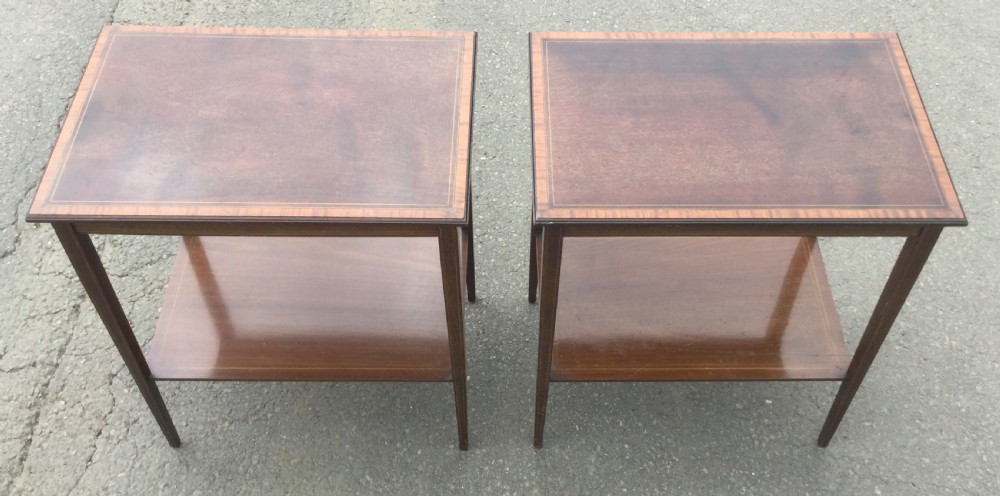A pair of rectangular Edwardian mahogany occasional tables featuring fine line inlay, tapered legs, and lower tier shelves. View IV