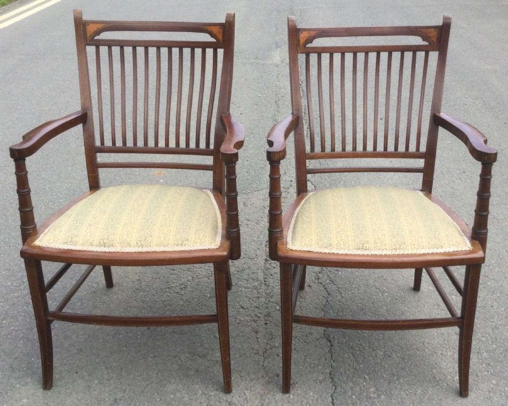 A pair of Edwardian mahogany salon armchairs featuring vertical slatted backs with marquetry inlay details on the top rail and upholstered patterned seats. View III