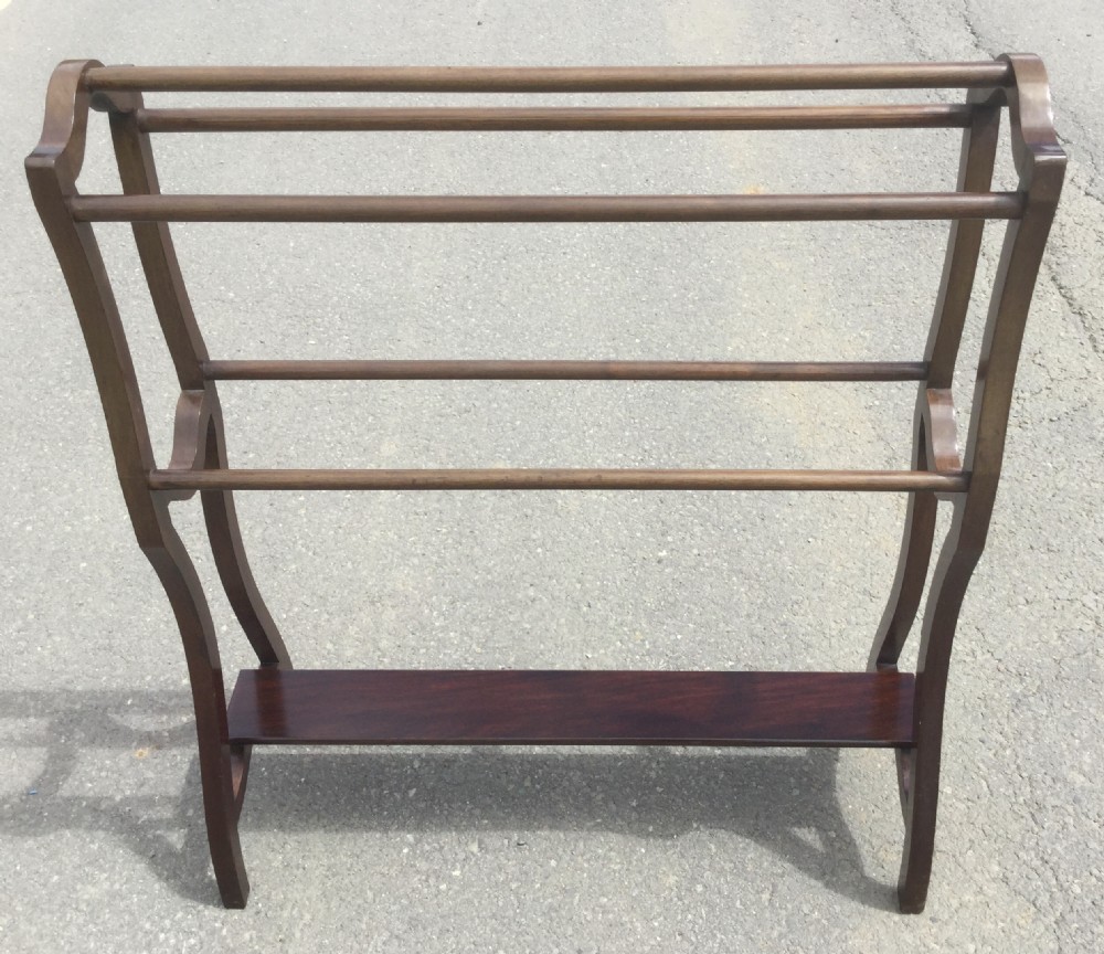 An Edwardian mahogany freestanding towel rail featuring five horizontal rungs, curved side uprights, and a lower shelf. View II