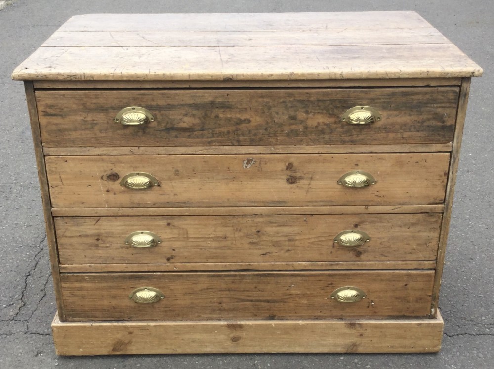 An Edwardian pitch pine plan chest featuring four wide drawers fitted with polished brass shell cup handles. View II