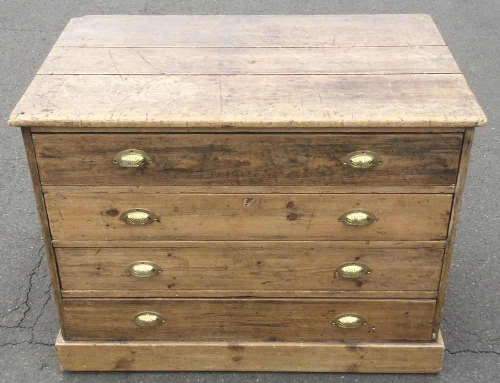 An Edwardian pitch pine plan chest featuring four wide drawers fitted with polished brass shell cup handles. View VI