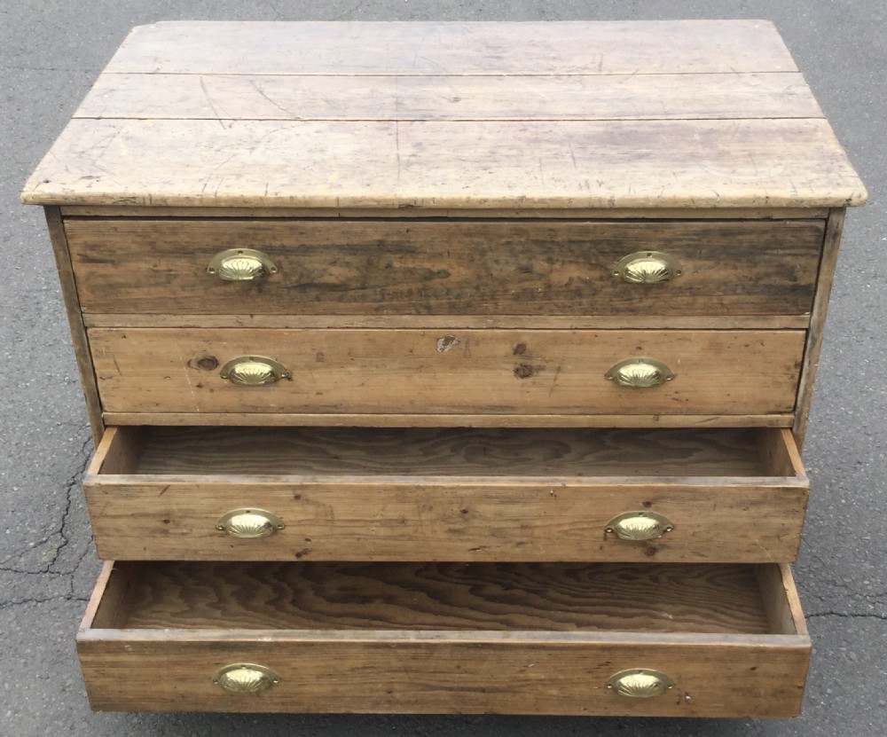An Edwardian pitch pine plan chest featuring four wide drawers fitted with polished brass shell cup handles. View VIII