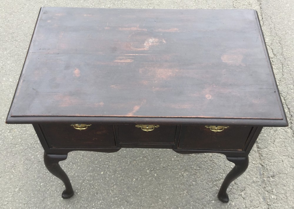 A Georgian dark oak side table featuring three front drawers with brass escutcheon plates, a shaped apron, and cabriole legs ending in pad feet. View VI