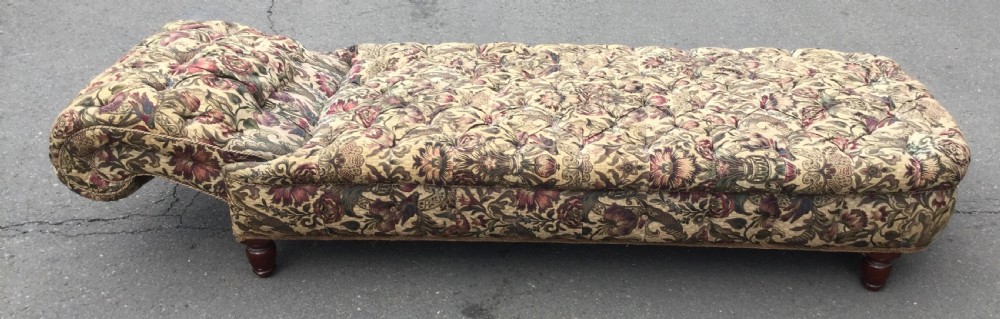 A Victorian upholstered daybed featuring deep-buttoned floral tapestry fabric with a scrolled end rest and turned wooden legs. View IX