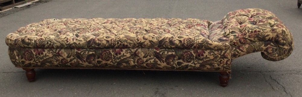 A Victorian upholstered daybed featuring deep-buttoned floral tapestry fabric with a scrolled end rest and turned wooden legs. View XI