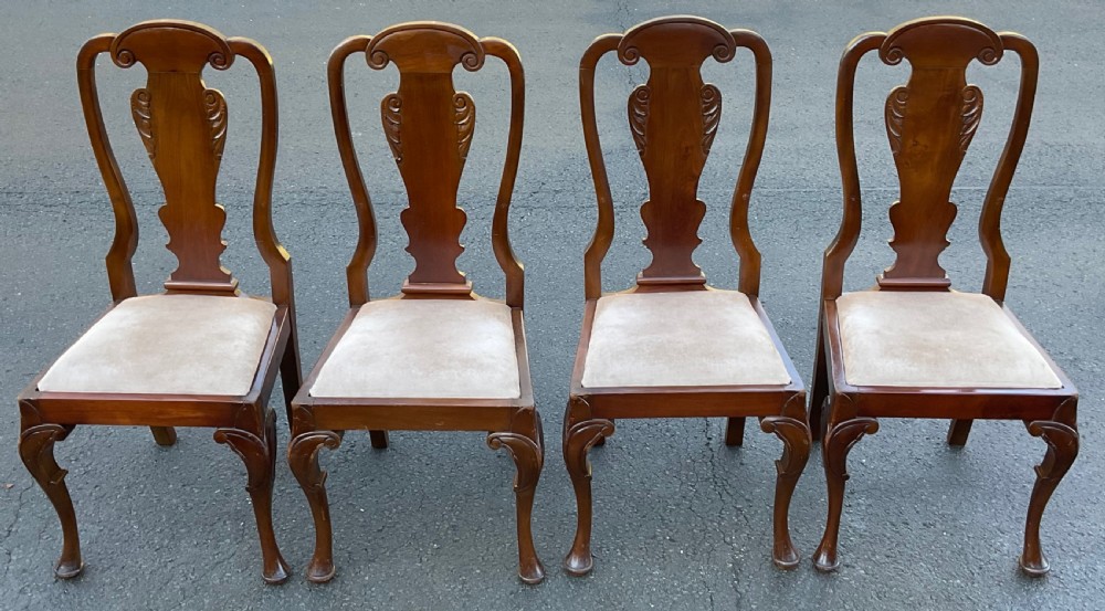 A set of four mahogany highback dining chairs featuring carved vase-shaped back splats, cabriole front legs, and neutral fabric upholstered seats. View II