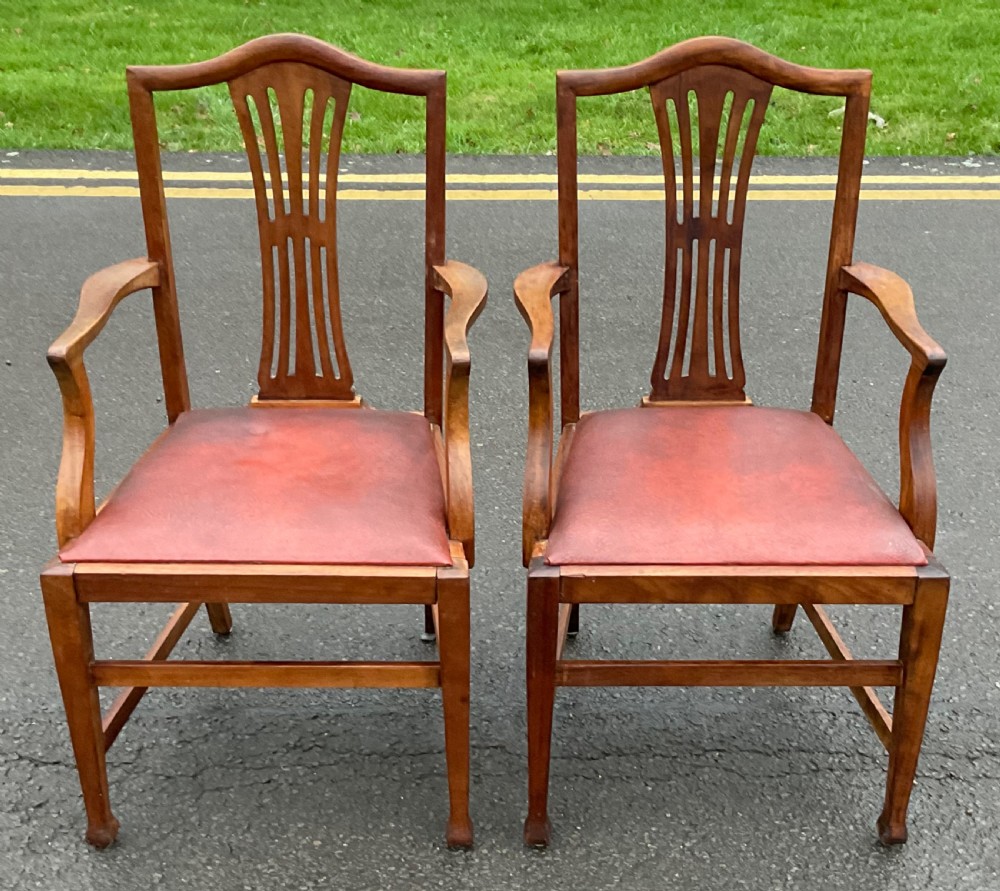 A pair of Georgian style mahogany carver armchairs with pierced splat backs and red leather padded seats. View II