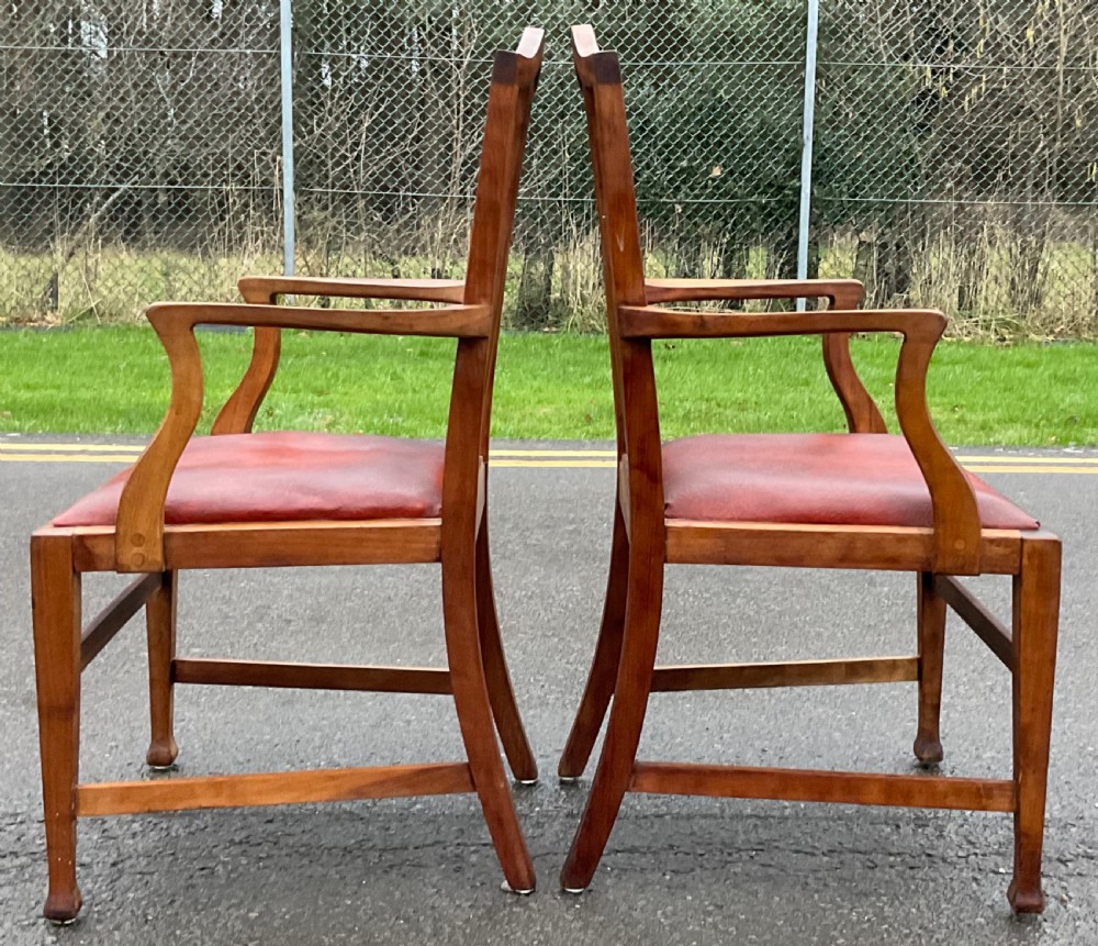 A pair of Georgian style mahogany carver armchairs with pierced splat backs and red leather padded seats. View IV