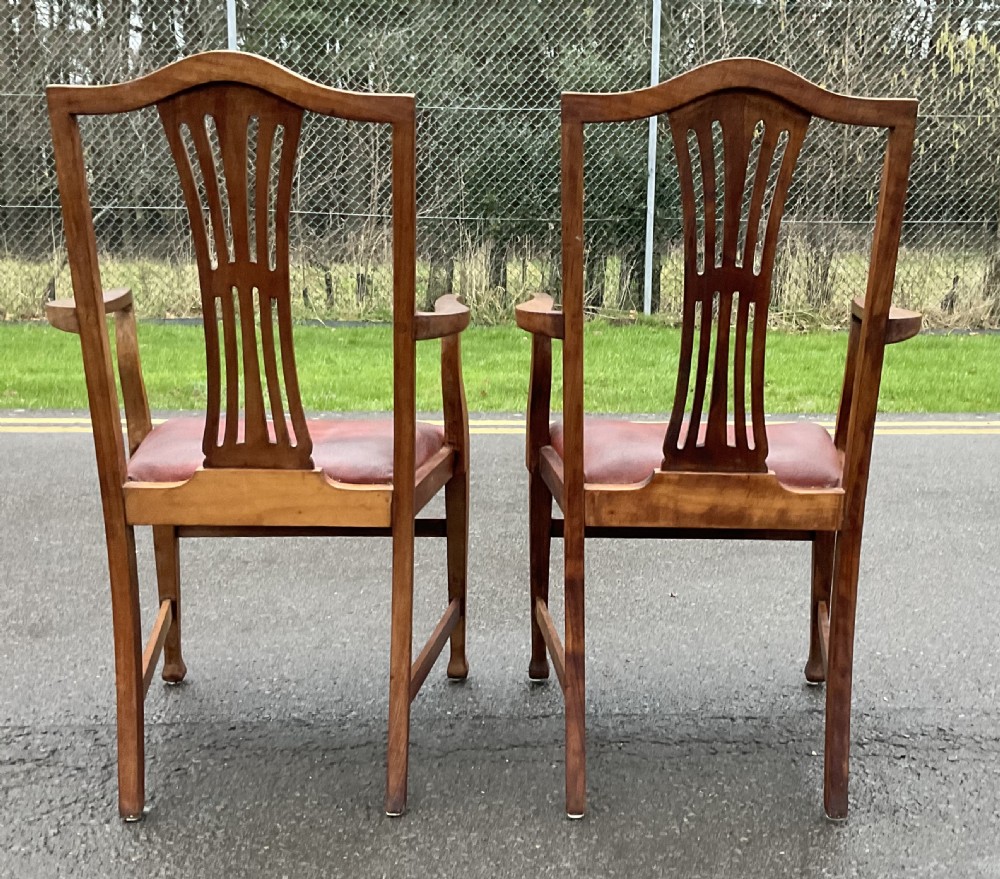 A pair of Georgian style mahogany carver armchairs with pierced splat backs and red leather padded seats. View VI