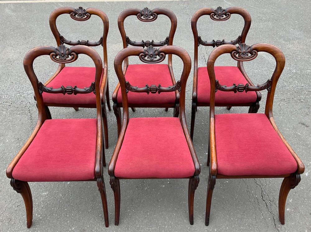 Set of six Regency rosewood dining chairs with carved balloon backs and red upholstered seats. View II