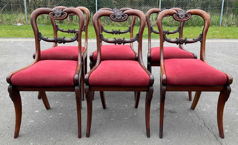 Set of six Regency rosewood dining chairs with carved balloon backs and red upholstered seats. View IV