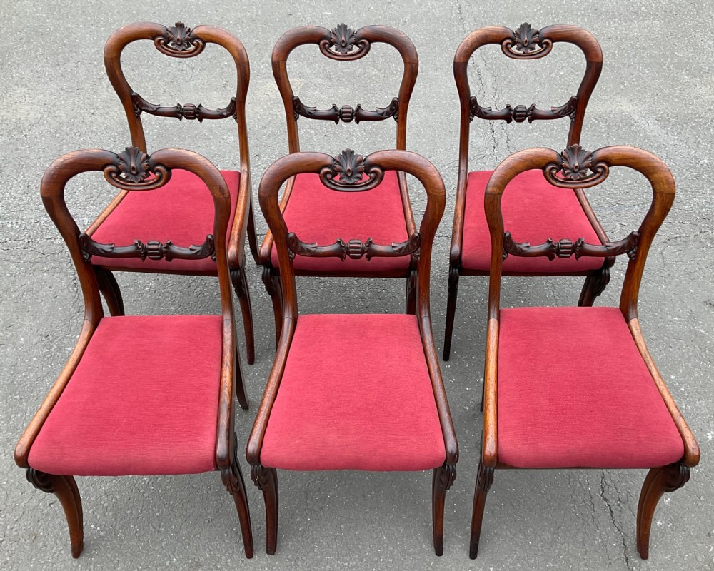 Set of six Regency rosewood dining chairs with carved balloon backs and red upholstered seats. View V