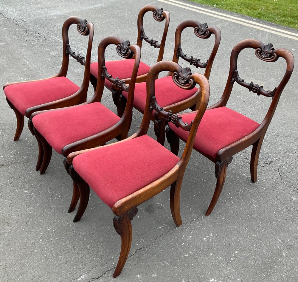 Set of six Regency rosewood dining chairs with carved balloon backs and red upholstered seats. View VIII