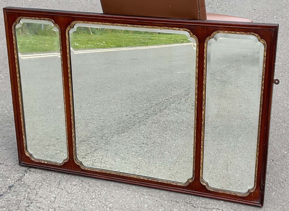 A horizontal walnut framed overmantel mirror featuring three separate glass panels with gilded inner slip borders. View II