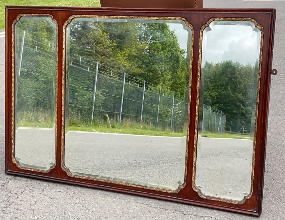 A horizontal walnut framed overmantel mirror featuring three separate glass panels with gilded inner slip borders. View III