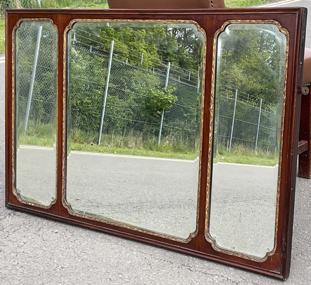 A horizontal walnut framed overmantel mirror featuring three separate glass panels with gilded inner slip borders. View VI