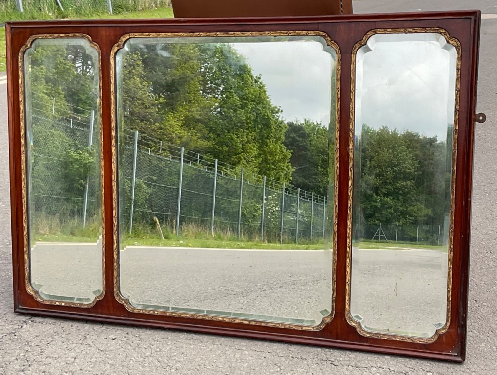 A horizontal walnut framed overmantel mirror featuring three separate glass panels with gilded inner slip borders. View VII