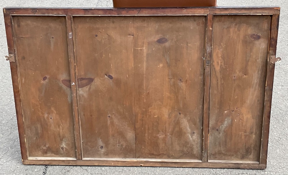 A horizontal walnut framed overmantel mirror featuring three separate glass panels with gilded inner slip borders. View X