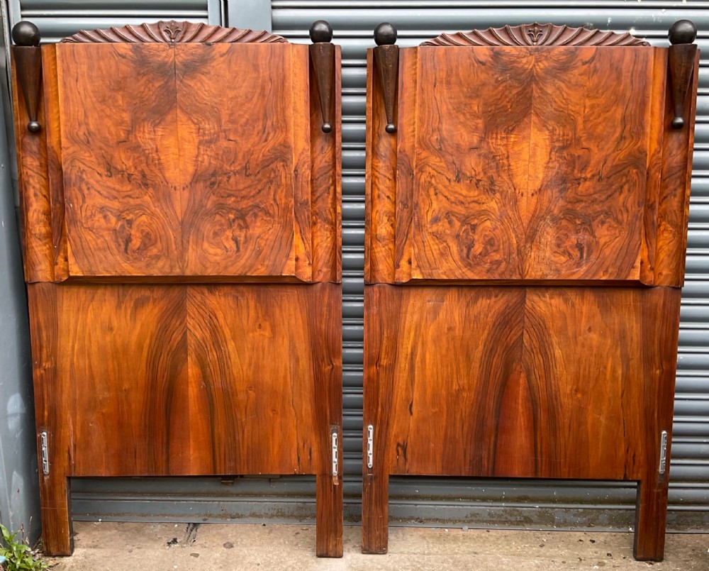 A pair of Art Deco burr walnut single bed frames featuring carved fan crests and geometric posts. View II