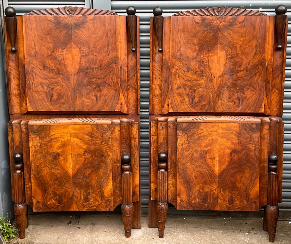 A pair of Art Deco burr walnut single bed frames featuring carved fan crests and geometric posts. View IX
