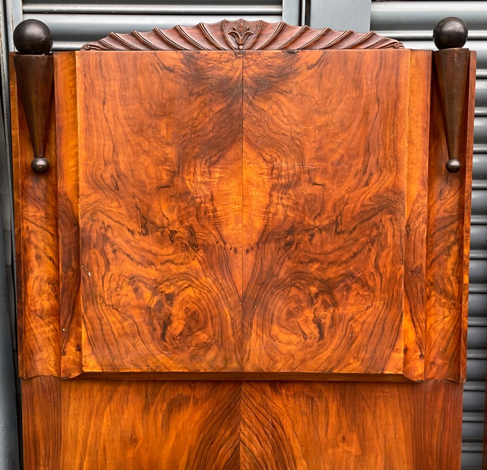 A pair of Art Deco burr walnut single bed frames featuring carved fan crests and geometric posts. View X