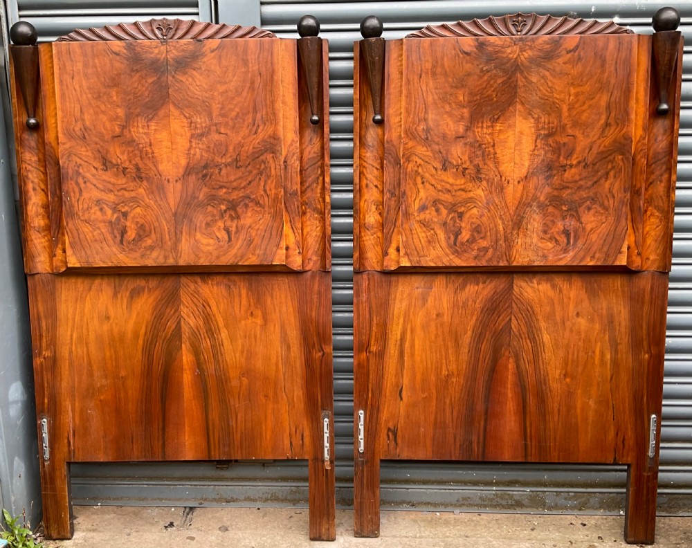 A pair of Art Deco burr walnut single bed frames featuring carved fan crests and geometric posts. View XI