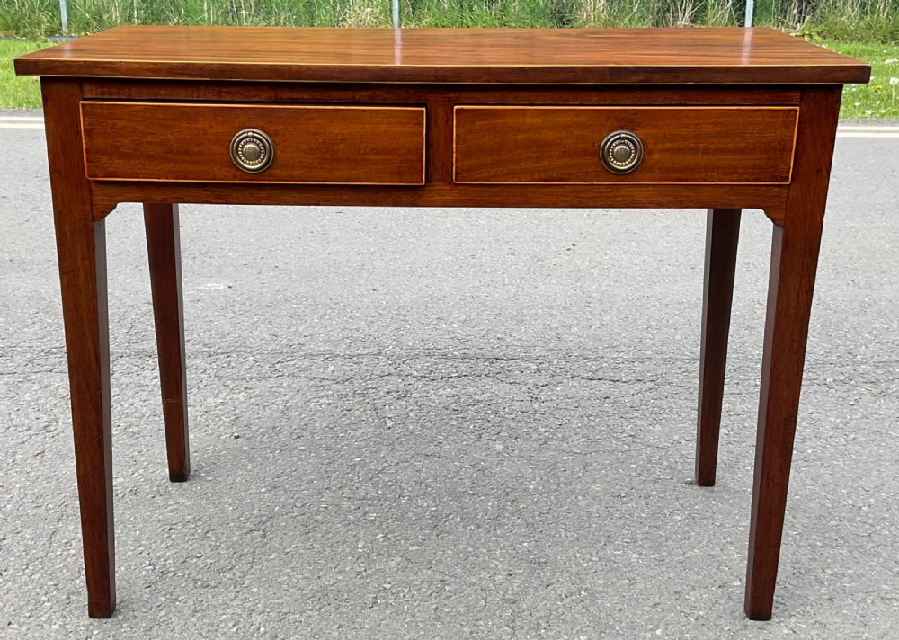 A Georgian mahogany side table featuring two drawers with brass ring handles and straight tapered legs. View III