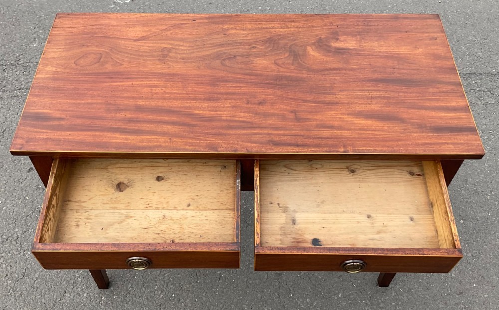 A Georgian mahogany side table featuring two drawers with brass ring handles and straight tapered legs. View VI