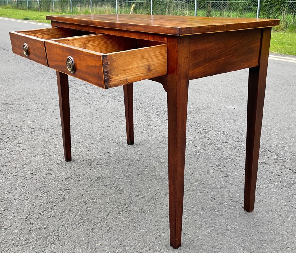 A Georgian mahogany side table featuring two drawers with brass ring handles and straight tapered legs. View VIII